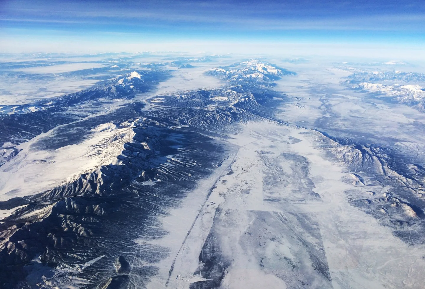 View of snow covered mountains from high altitude.