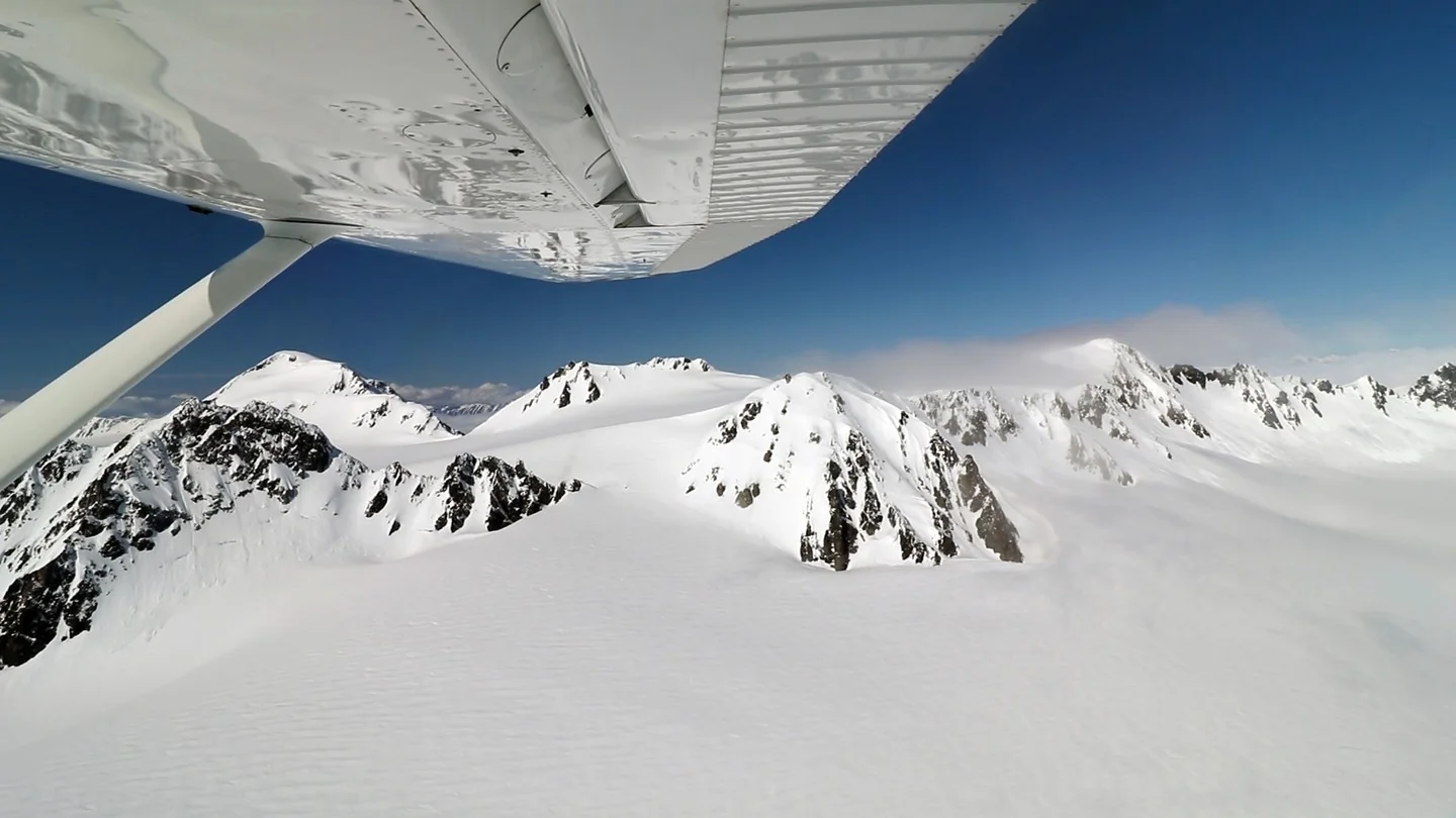 Tall mountains buried in mile-deep snow.